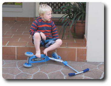 Boy sitting on step looking to side