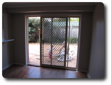 Sliding door (with screen) looking out to paved courtyard