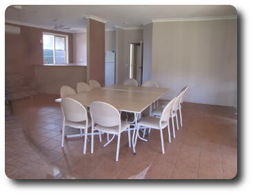 Table with chairs on tiled floor inside building