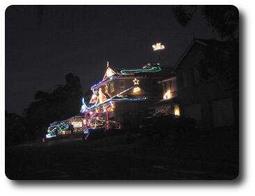 House and front garden overloaded with Christmas lights