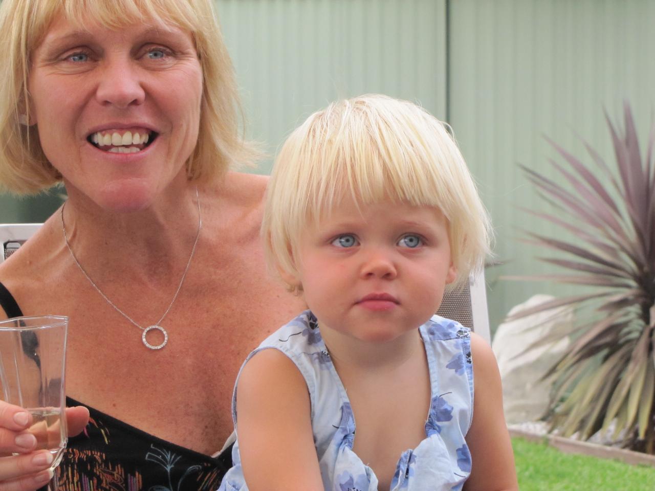 Blonde haired little girl on mum's lap