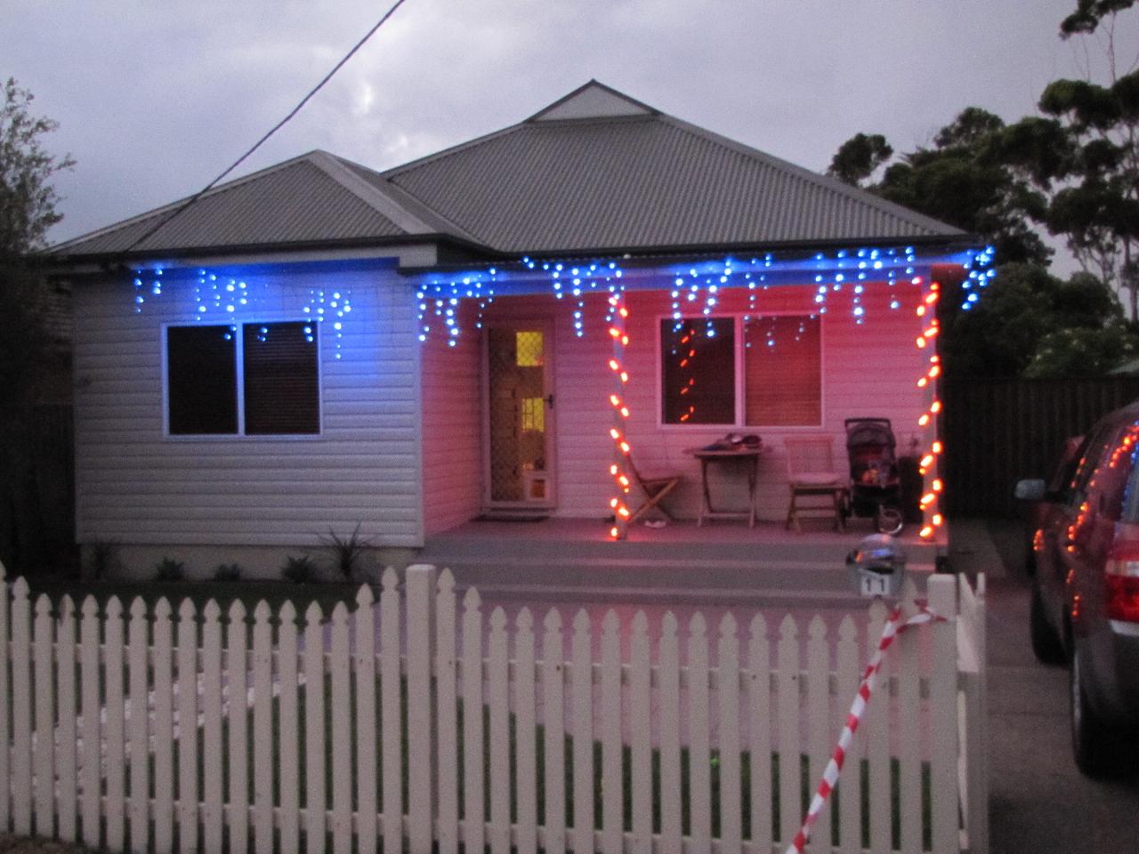 Double fronted house with blue, red lights