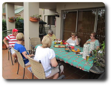 Adults sitting around outdoor table