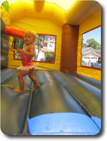 Little girl in inflatable jumping castle