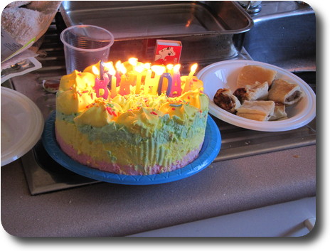 Ice cream cake with candles lit