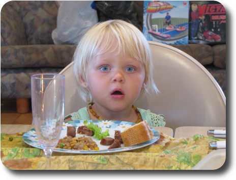 Little girl sitting at table