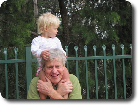 Little girl on shoulders of man, but looking away