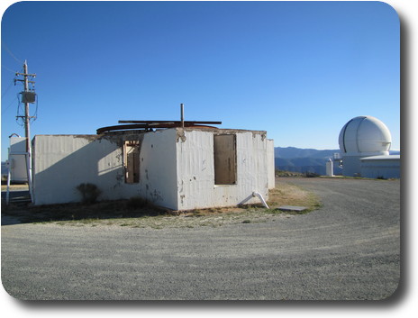 Small, white roofless telescope building