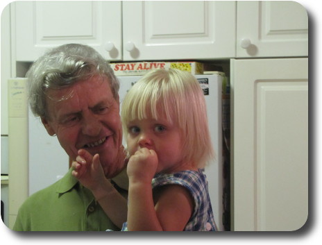 Grandfather with granddaughter in arms