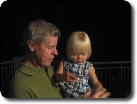 Grandfather with granddaughter in arms