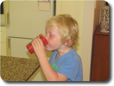 Boy drinking from red cup