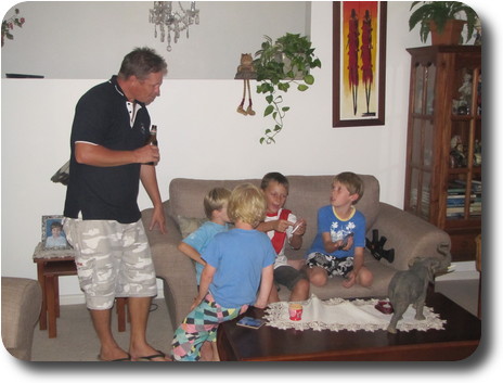 Boys on lounge with man at left hand end