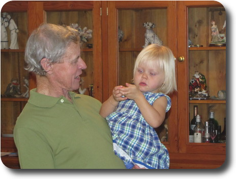 Grandfather with granddaughter in arms