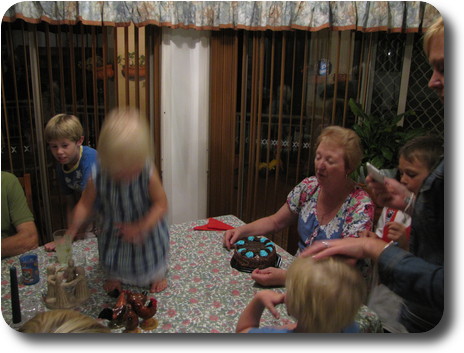 Blurred little girl standing on dining table