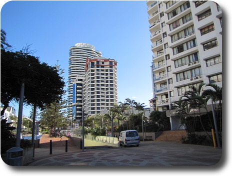 Tall aparment buildings, one with wavy balconies