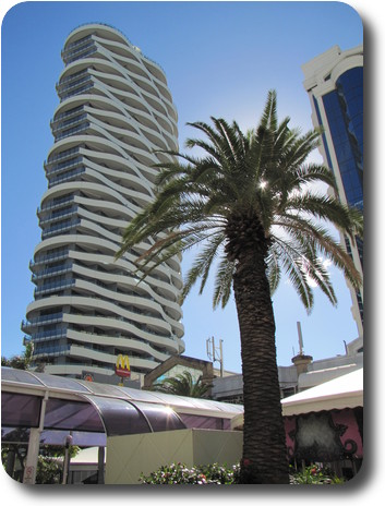 Wavy building, with palm tree and the golden arches