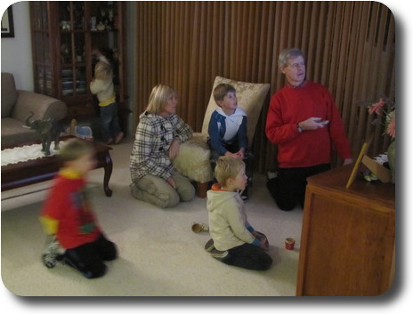 People sitting on floor looking at (hidden) TV