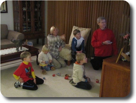 People sitting on floor looking at (hidden) TV