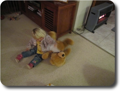 Child on floor with bear