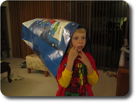 Boy with big carry bag as a hat