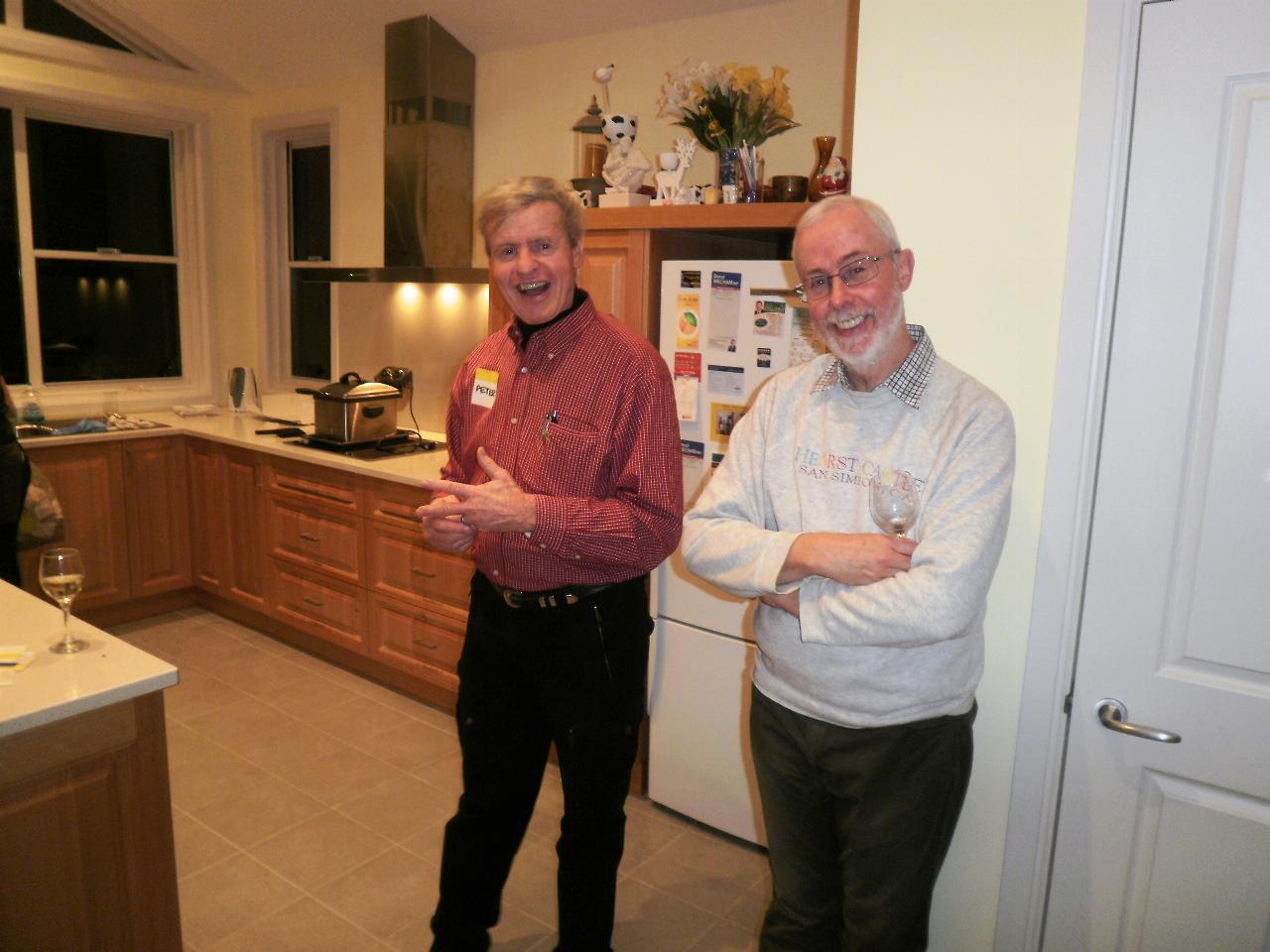 Two men standing in kitchen