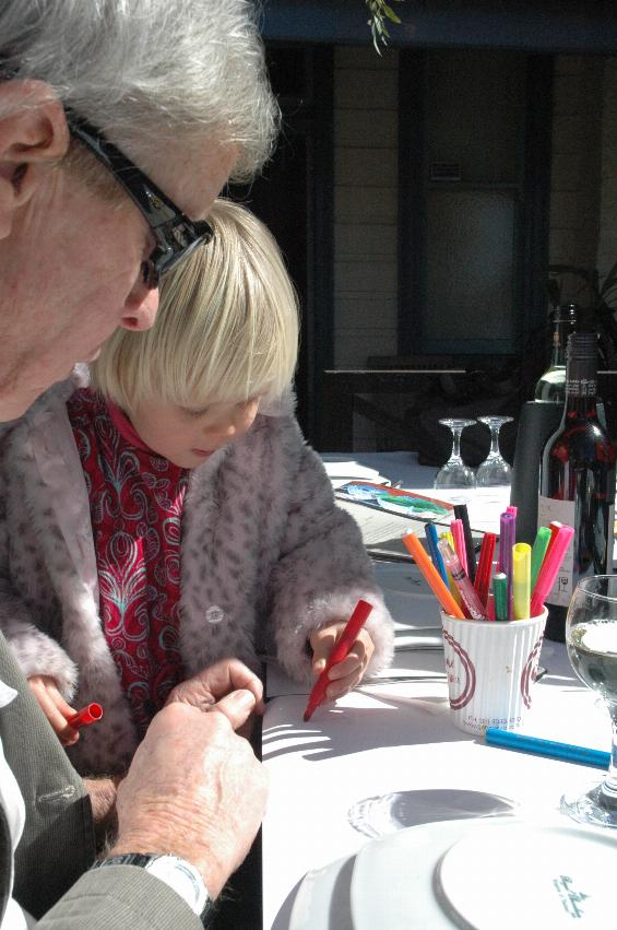 Little girl drawing on table