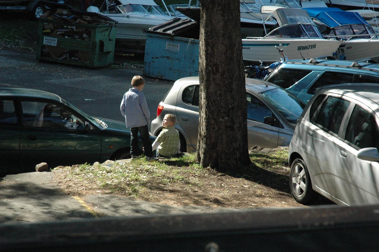 Boys amongst cars in car park