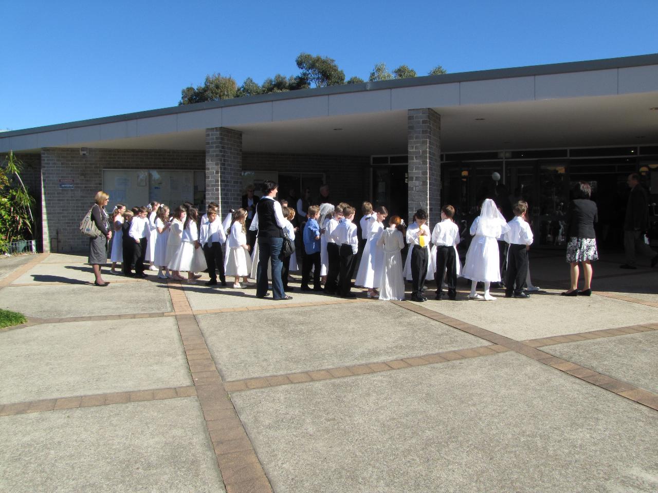 Boys and girls lined up waiting to enter church