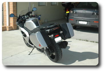 Rear view of silver/black motorcycle with panniers