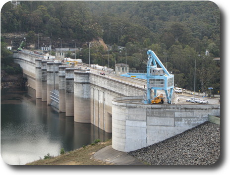 Rear of dam wall, with construction vehicles and main spillway gate