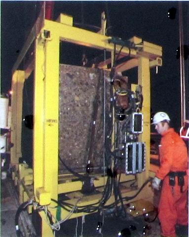 The steel frame holding the concrete block, operator next to it