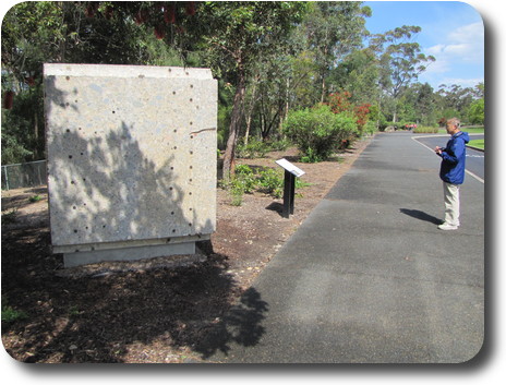 Large concrete block, with reinforcing bars, taller than man standing near