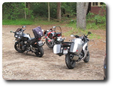 3 motorcycles on side of road