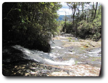 Small stream over rocks disappearing in distance