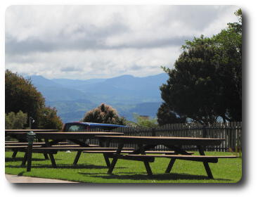 View over tables to distant rugged hills and valleys, overcast sky