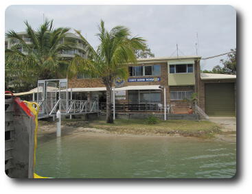 Brick building at water's edge with wharf and radio room