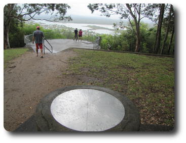 Disc pointing to landmarks, then Noosa and river in distance below