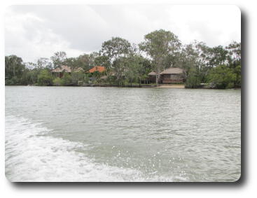 Native village style huts along the river bank