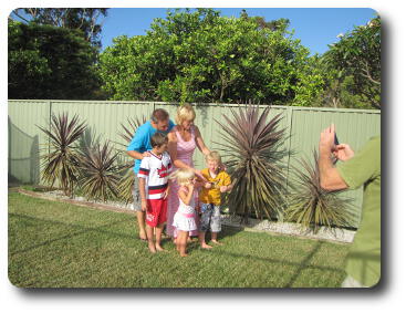 Mum,dad, two sons and daughter in garden