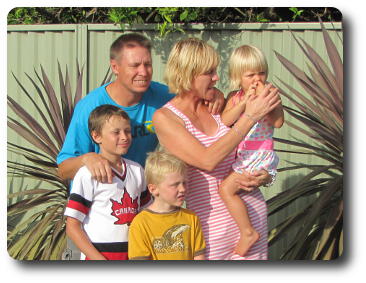 Mum,dad, two sons and daughter in garden