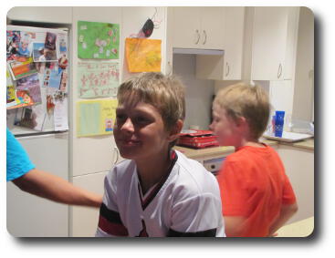 Boy sitting on kitchen counter