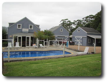 Pool with 3 gray buildings in U shaped arrangement