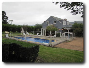 Swimming pool, gray building and distant hills