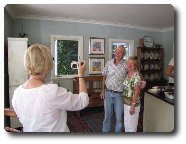 Woman, back to camera, photographing couple