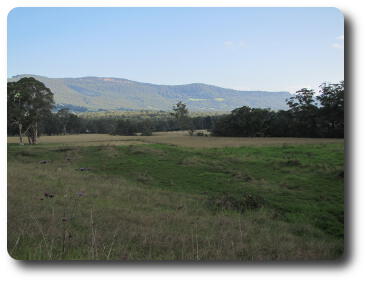 Foreground meadow now in shade, distant hills still sunny