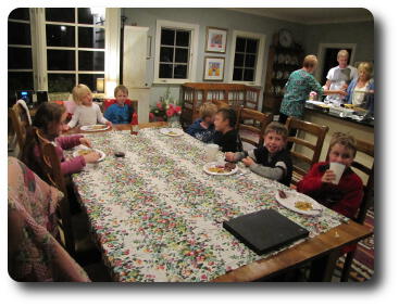 Youngsters sitting around dining room table