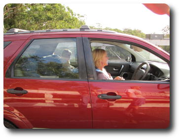 Mother and child in red SUV on bridge