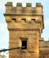 Sandstone tower with suspension cable through it