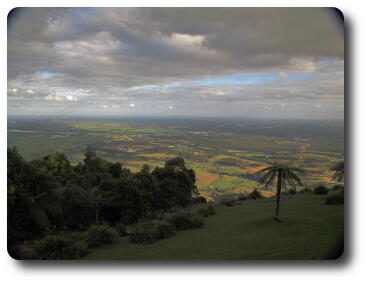 View from mountain over plain with river, out to sea