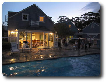 Evening scene with pool and illuminated house behind